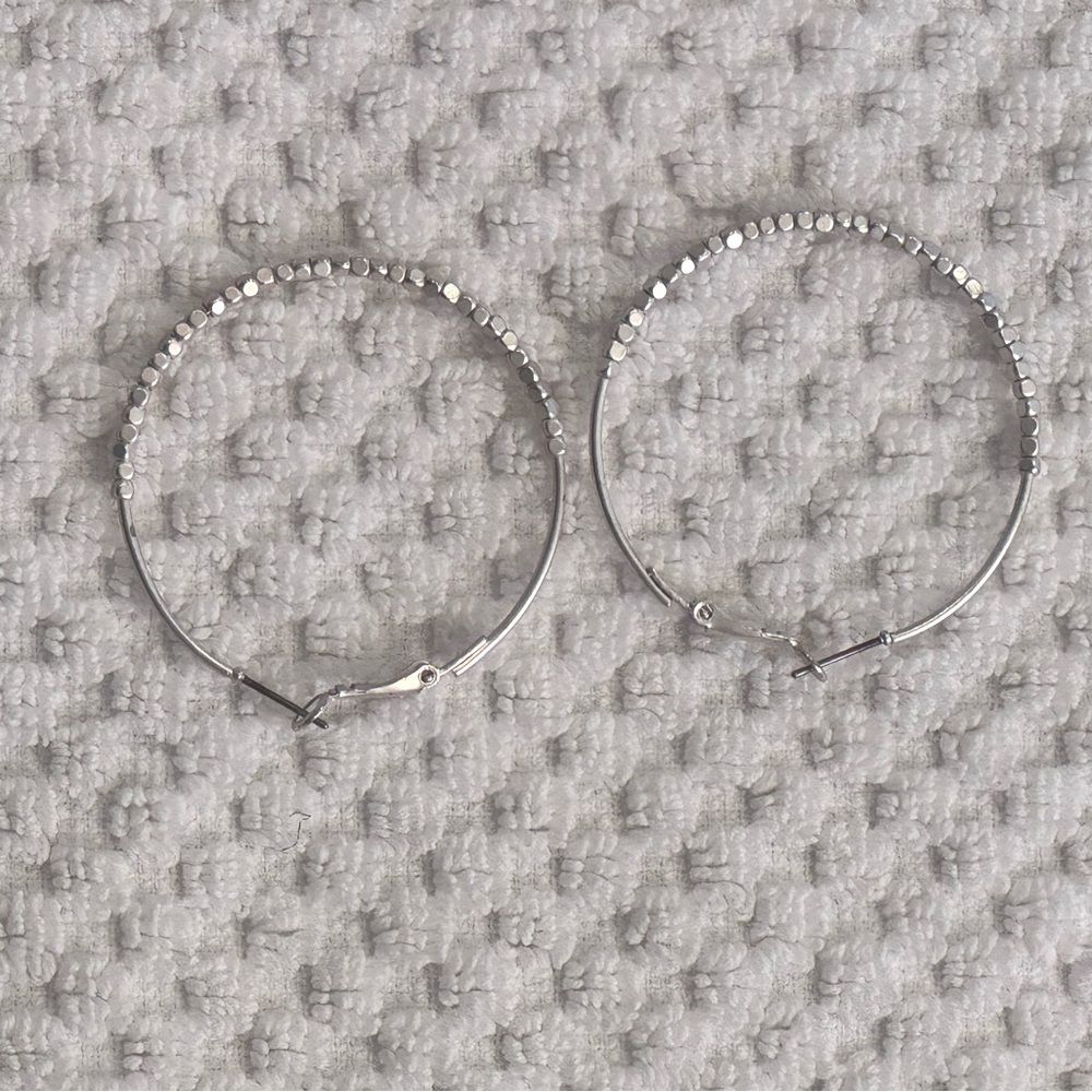 Metal hoop earrings. Silver color with little hammered metal beads.